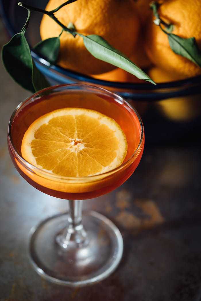 Enchanting Earl Grey tea cocktail made with Grand Marnier and garnished with an orange slice