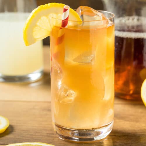 arnold palmer drink in glass with straw and lemon slice