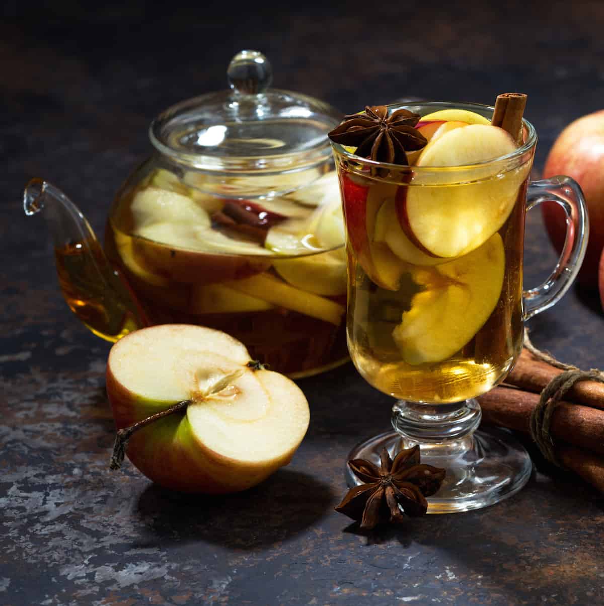 apple tea in glass teapot and glass mug