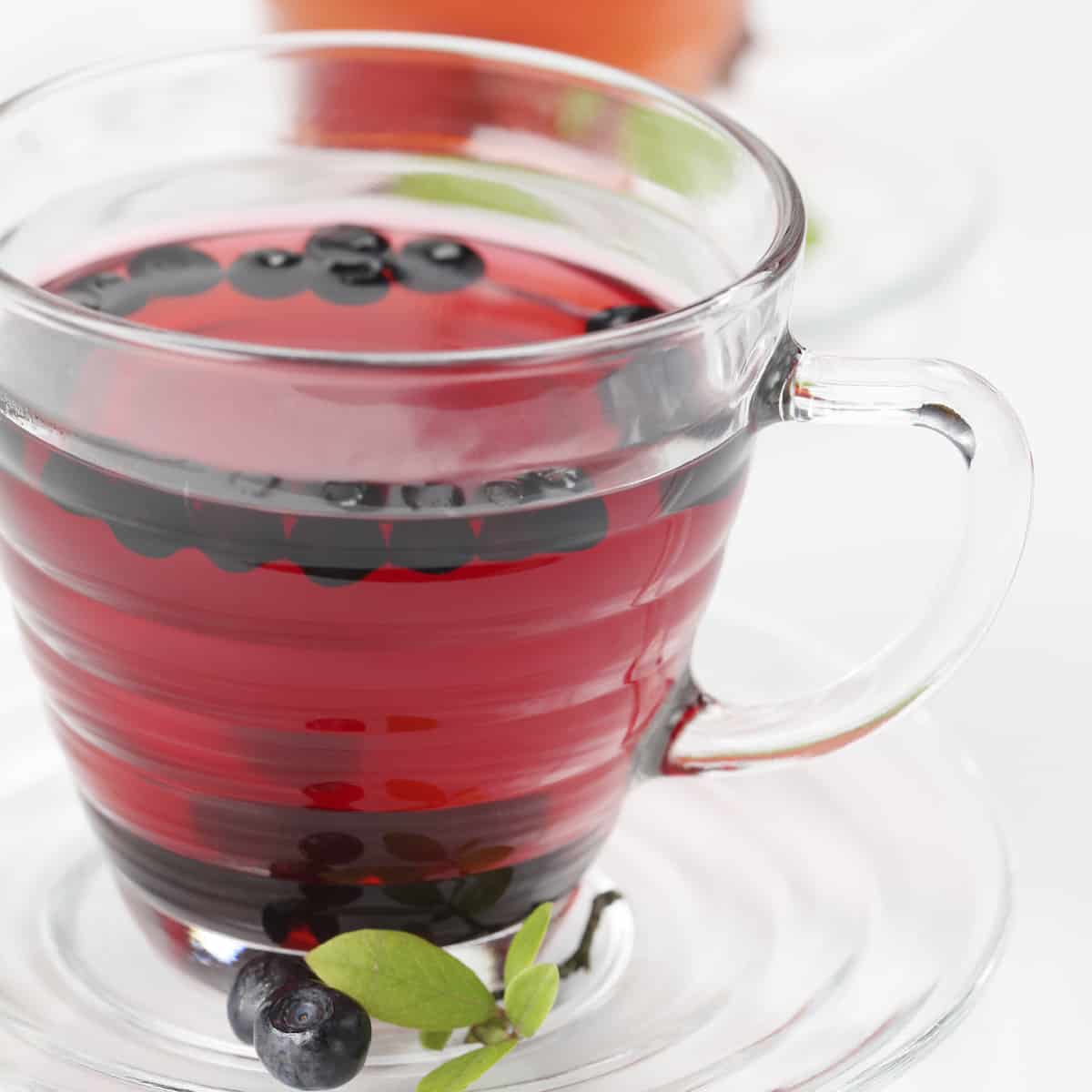 Fresh blueberry and raspberry tea in glass cups.