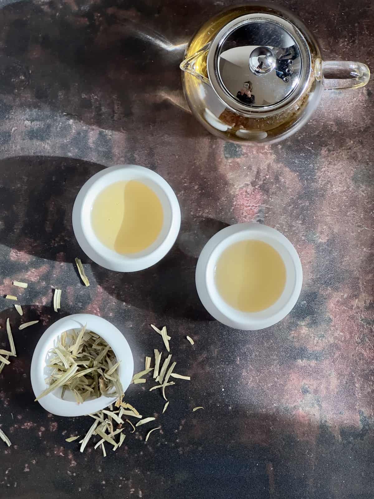 sea buckthorn tea overhead brewed in cups and dry leaf